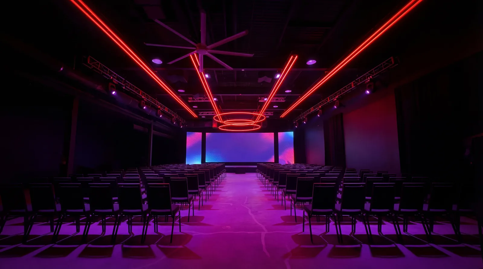 LED wall lighting a Demo Room event space with seated rows