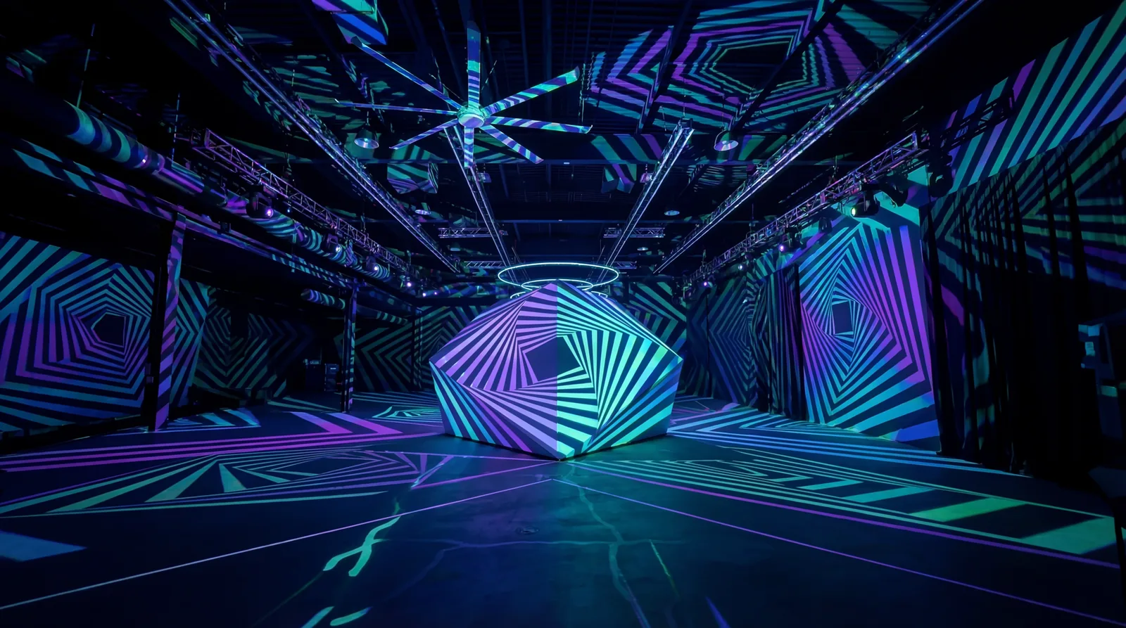 Projection-mapped geometric patterns wrapping a full room