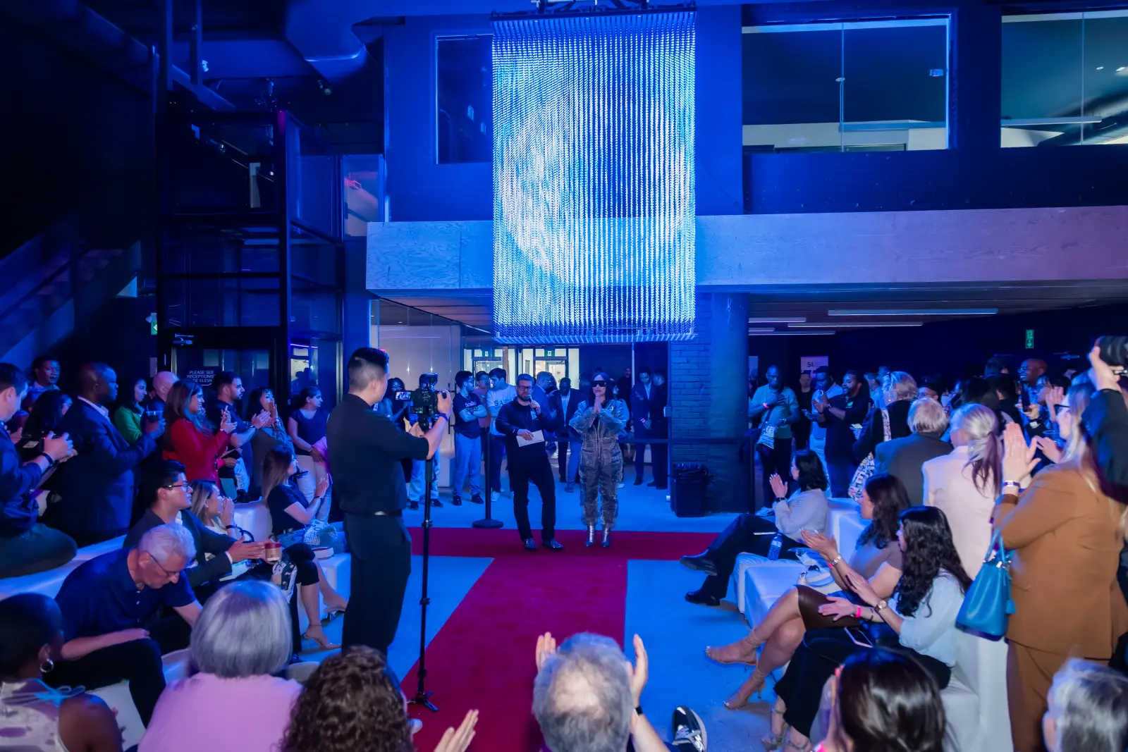 Evening mixer beneath a suspended LED light curtain, video still